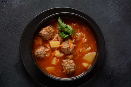 Patatesli Sulu Kofte - Turkish soup with meatballs in black bowlの写真素材