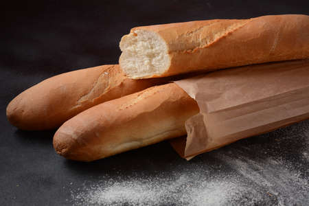 French fresh bread baguettes  on a dark background