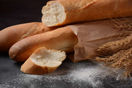 French fresh bread baguettes  on a dark backgroundの写真素材