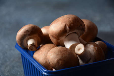 Fresh champignon mushrooms in plastic boxの写真素材