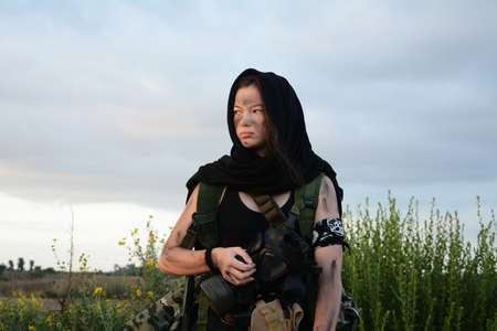 A female militia soldier in a post apocalyptic desert wasteland. Urban combat and wasteland
