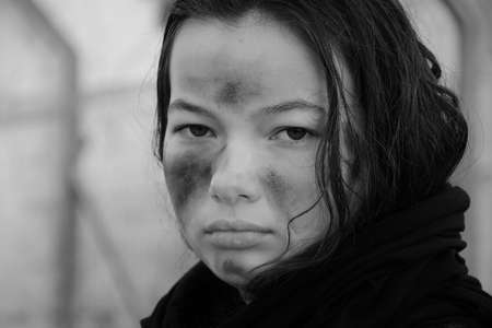 A portrait  of a teenage girl militia soldier in a post apocalyptic desert wasteland. Urban combat and wastelandの写真素材