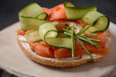 Bagel sandwich with salmon, cream cheese, cucumber,の写真素材