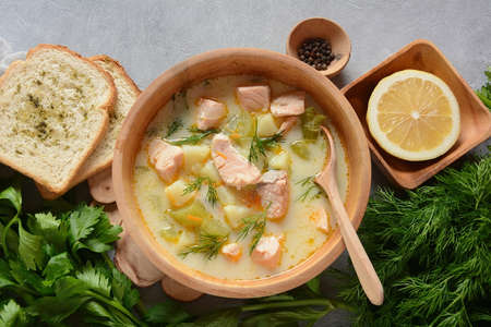 Creamy fish soup with salmon, potatoes, onions , carrots, dill and celery . Kalakeitto- traditional dish of the Finnish cuisine or Russian  Ukha Fish Head Soup. Healthy Food Concept. Omega -3の写真素材