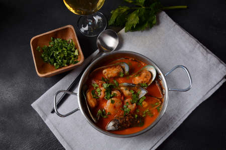 French seafood bouillabaisse soup/fish stew with mussels served with garlic toast baguetteの写真素材
