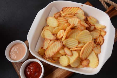 Homemade rippled potato chips and sauce, ketchupの写真素材