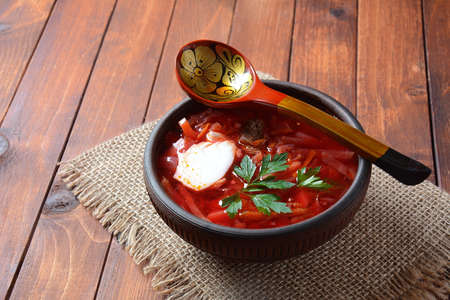 Traditional Ukrainian Russian borscht . Bowl of red beet root soup borsch with white cream . Beet...