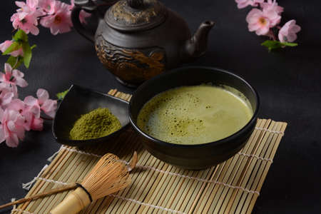 Green matcha tea drink and tea accessories on white background. Japanese tea ceremony concept. Detox...