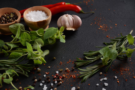 Spices and herbs on dark stone backgroundの写真素材