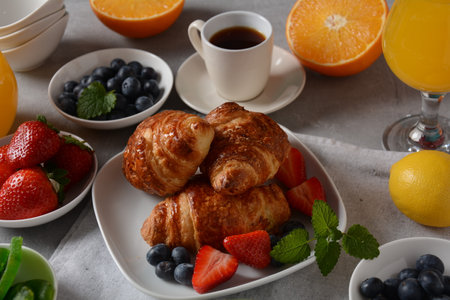 Tasty breakfast. Croissants, fresh and dried fruits, fresh juiceの写真素材