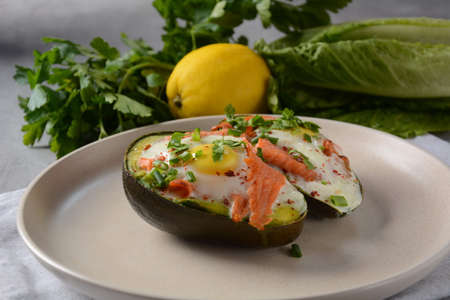 Baked smoked salmon, egg in avocado, ketogenic keto low carb diet food