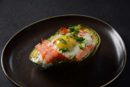 Baked smoked salmon, egg in avocado, ketogenic keto low carb diet foodの写真素材
