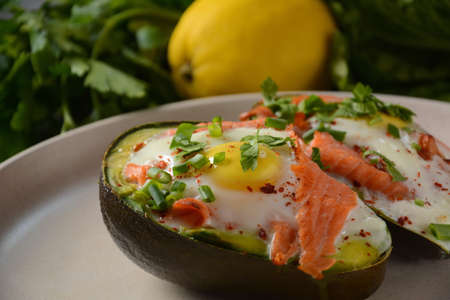 Baked smoked salmon, egg in avocado, ketogenic keto low carb diet foodの写真素材