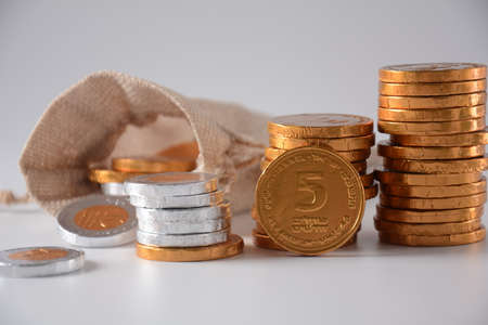 Stack of chocolate shekel coins as a concept for finance