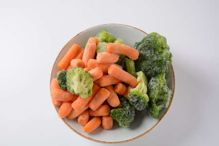 Small frozen pieces of  broccoli and carrots.  Healthy food. Frozen vegetablesの写真素材