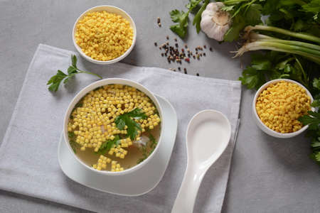 Chicken soup , chicken broth, with pieces of chicken and vegetables and shkedei marak an Israeli...