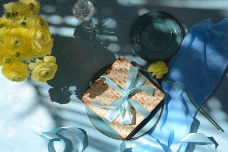 Table served for Passover (Pesach) indoors, with matzah bread as symbolic Pesach (Passover Seder)...
