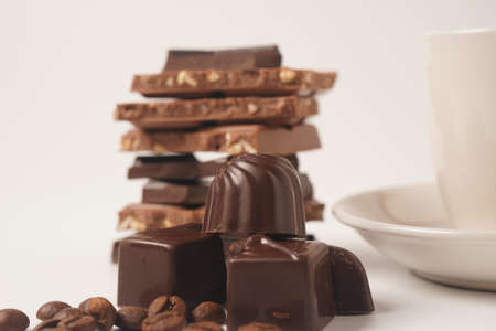 Chocolate tower. Stack of chocolate pieces. The chunks of broken chocolate. Background with...