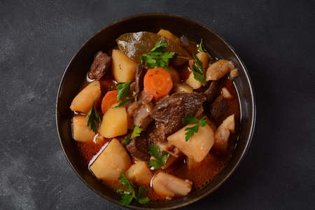 Irish stew made with beef, potatoes, carrots and herbs.の写真素材