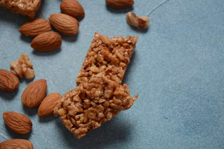 Various healthy granola bars (muesli or cereal bars). Set of energy, sport, breakfast and protein bars. Puffed rice, berries, chocolate, oatmeal, almond and honey cereal bars.の写真素材