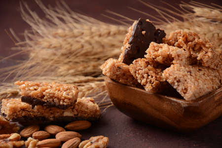 Various healthy granola bars (muesli or cereal bars). Set of energy, sport, breakfast and protein bars. Puffed rice, berries, chocolate, oatmeal, almond and honey cereal bars.の写真素材