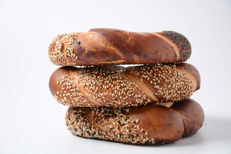 Fresh bread bagel with poppy and  sesame coating. Jewish or  German  form of sweet-filled pastry