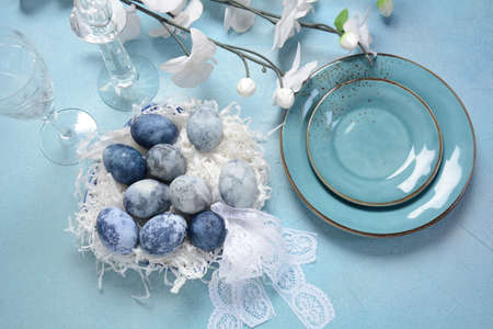 Easter table setting.  Decorated Easter eggs  in an Easter basket
