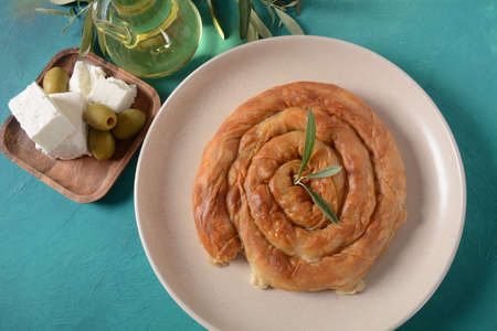 Greek spanakopita or spiral pie made of phyllo dough, spinach. Traditional feta cheese phyllo pastry...