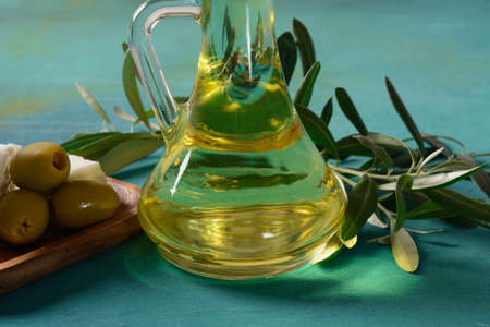 Feta cheese with green olives, olive oil, and young olive branch. Fresh Greek Feta Cheese. Healthy ingredient for cooking salad.の写真素材