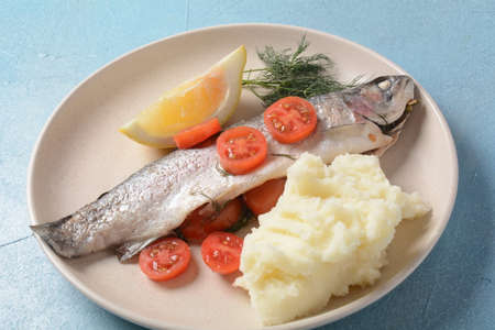 Perfectly baked oven trout with lemon and dill  with cherry tomatoes, olive oil, lemon juice in foil