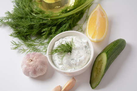 Traditional greek dip sauce or dressing tzatziki prepared with grated cucumber sour cream yogurt olive oil and fresh dill.の写真素材