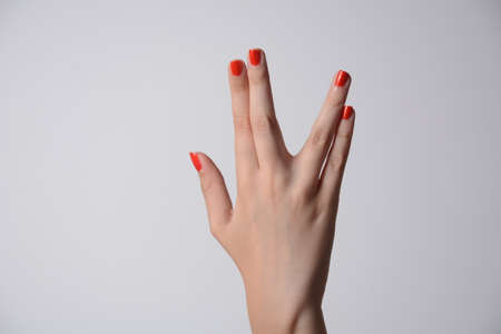 A girl hand doing the Vulcan salute on a white background. Vulcan hand salute against. Spock hand....