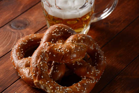 Bavarian freshly baked  homemade soft pretzel with beer. Rustic style. Oktoberfest