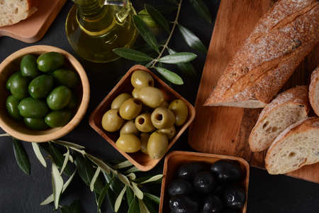 Olives, olive branch ,Olive oil on wooden background