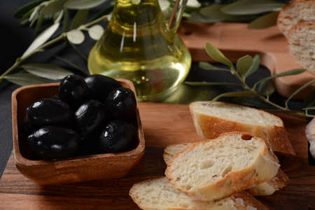 Olives, olive branch ,Olive oil on wooden backgroundの写真素材