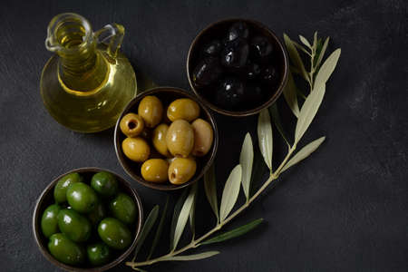 Olives, olive branch ,Olive oil on wooden backgroundの写真素材