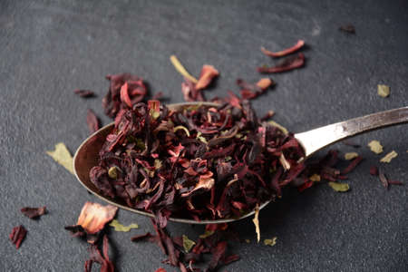 Dry Hibiscus tea in a spoon. Tea conceptの写真素材