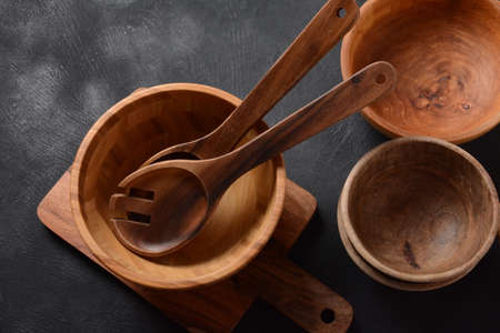 Culinary background, empty ceramic plates, wooden or bamboo spoons and bowls   . Rustic style. Home...