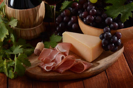 Antipasto with grape, cheese and prosciutto, , selective focusの写真素材