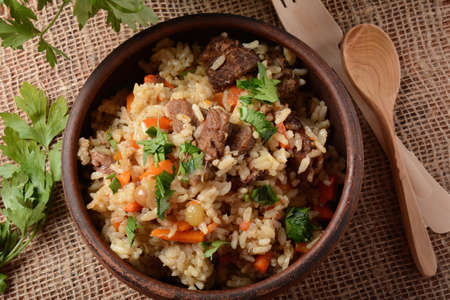 Fried and stewed beef meat with rice. Uzbek cuisine  pilaf (plov)の写真素材