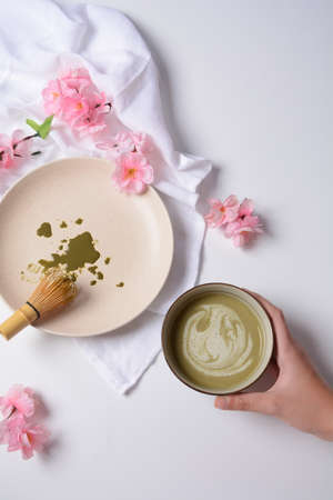 Matcha green tea latte in a bowl. Matcha is a powder of green tea leaves packed with antioxidants.