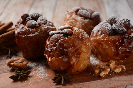 Baked apples with nuts and raisins. Homemade baked apples in the oven, with sugar powder close-up. Holiday dessertの写真素材