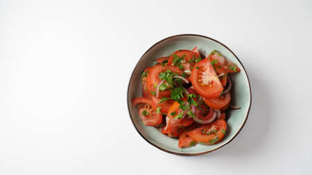 Tomato salad with red sweet onion, cut parsley and olive oilの写真素材