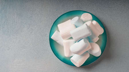 Pink ,white and blue marshmallows on a plateの写真素材