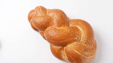 Uncovered challah bread for Shabbat on white background.