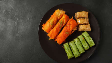 A tray of Turkish pastries including baklava, knafeh -  a Middle Eastern cheese pastry soaked in sweet, sugar-based syrupの写真素材