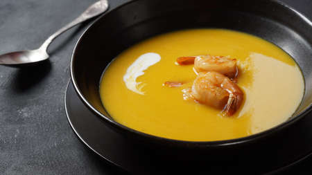 Creamy pumpkin soup with shrimps. Healthy organic pumpkin cream soupの写真素材