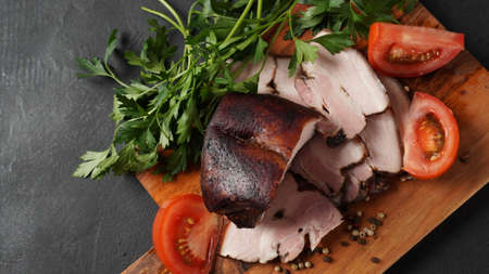 Smoked pork belly , cured bacon with sliced strip and spices on wooden cutting boardの写真素材