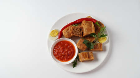 Jachnun or Jahnun, Yemenite Jewish pastry, served with fresh grated tomato and boiled egg and Zhug,  originating from the Adeni Jews, and traditionally served on Shabbat morning in Israel.の写真素材