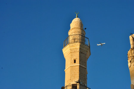 Minaret of a mosque on the sunset over blue skyの写真素材
